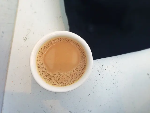 In the center of the image there is a tea in cup on the floor.