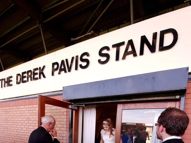 In the foreground of this image, there are two men wearing suits are on the floor. In the...