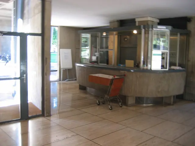 In a room there is a trolley, reception desk, doors and a board.