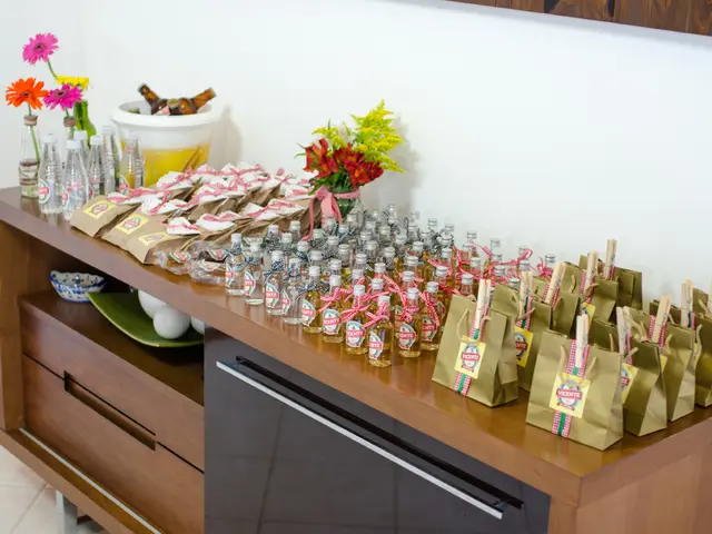 In the image we can see there is a table on which there are wine bottles and there are covers kept...