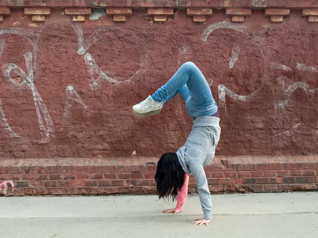 In this image I can see a person doing some exercise in the foreground on the road in the...