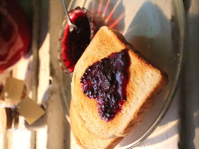 In this picture, it seems like heart shape jam on the bread and a spoon and liquid in a bowl in the...